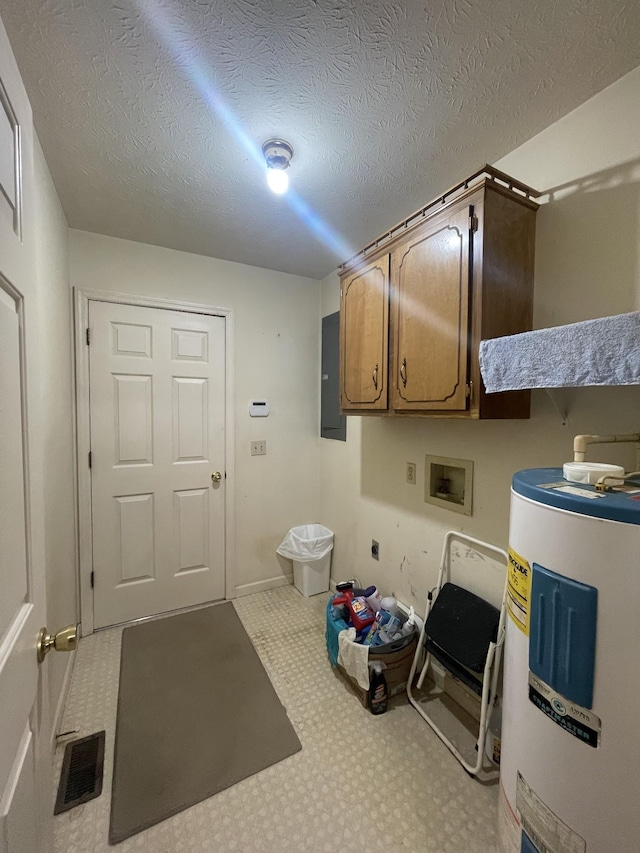 kitchen featuring electric panel, water heater, and a textured ceiling