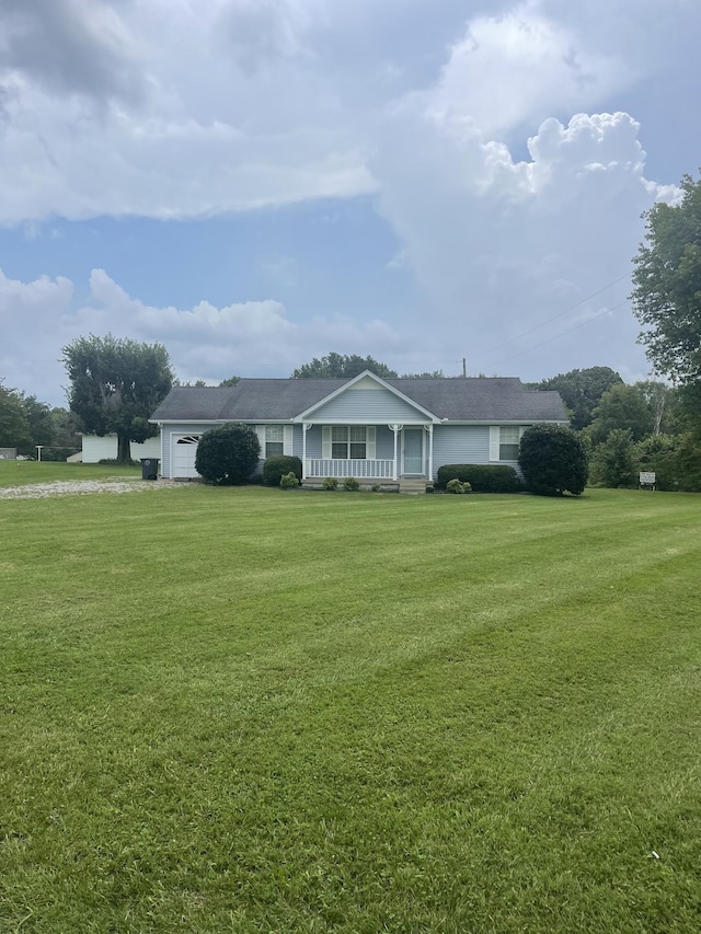 single story home featuring a garage, covered porch, and a front lawn