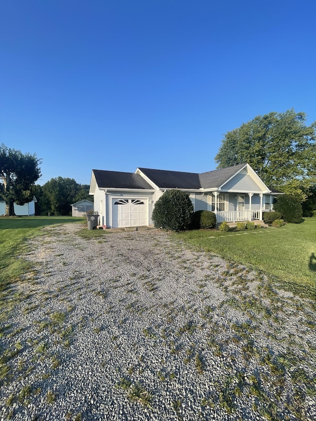 ranch-style house with a porch, a garage, and a front lawn