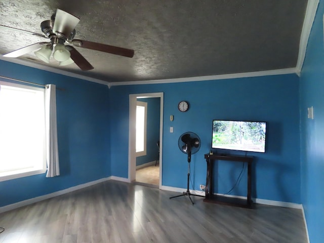 spare room with ornamental molding, ceiling fan, and dark hardwood / wood-style flooring