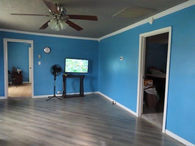 empty room featuring ornamental molding, hardwood / wood-style floors, and ceiling fan