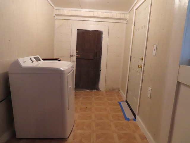 washroom with wood walls, separate washer and dryer, and light parquet floors