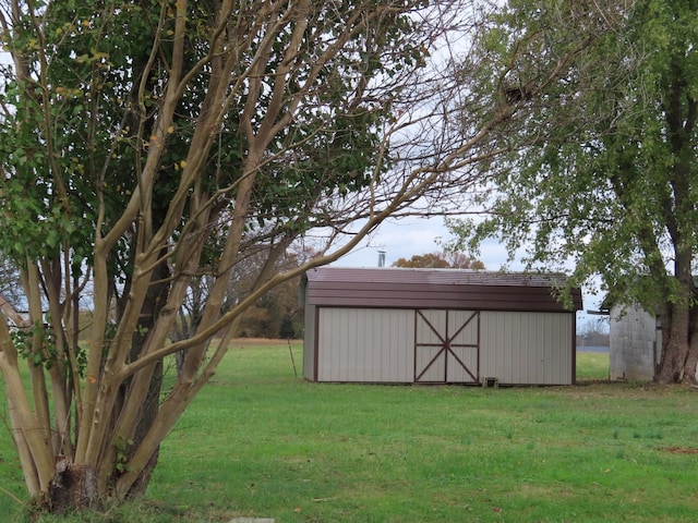 view of outbuilding featuring a lawn