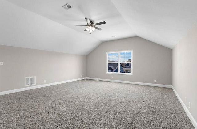 additional living space with vaulted ceiling, carpet flooring, and ceiling fan