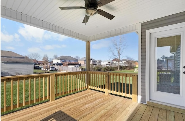 deck with a yard and ceiling fan