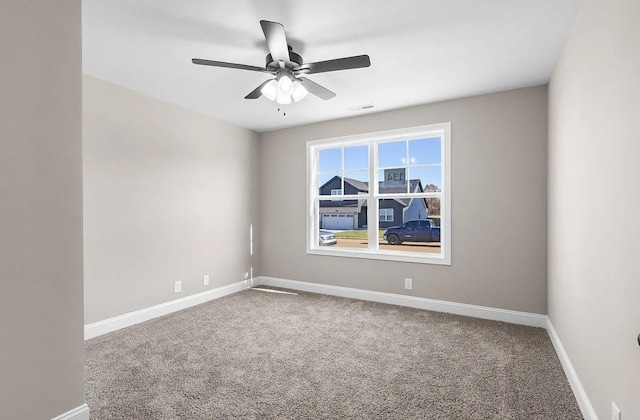 carpeted empty room featuring ceiling fan