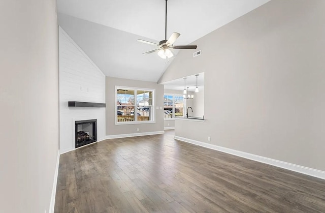 unfurnished living room with ceiling fan, high vaulted ceiling, dark hardwood / wood-style floors, and a fireplace