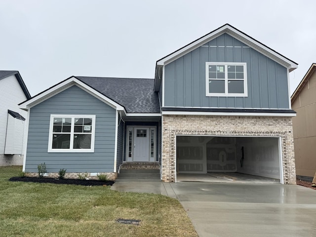 view of front of property featuring a front yard, an attached garage, board and batten siding, and driveway