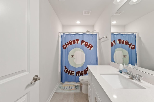 bathroom with tile patterned flooring, vanity, curtained shower, and toilet