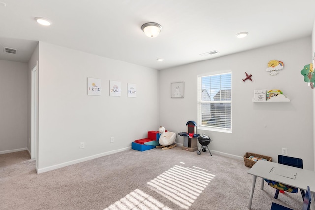 rec room featuring light colored carpet