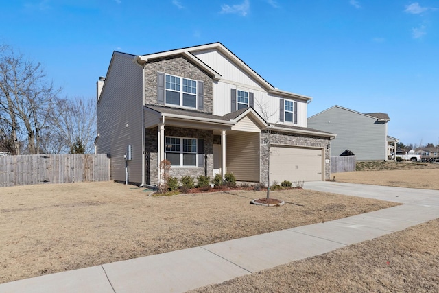 craftsman house with a garage and a front lawn