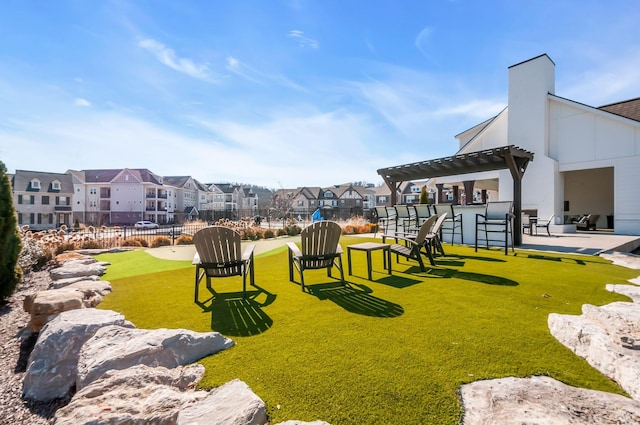 view of community featuring a pergola and a lawn