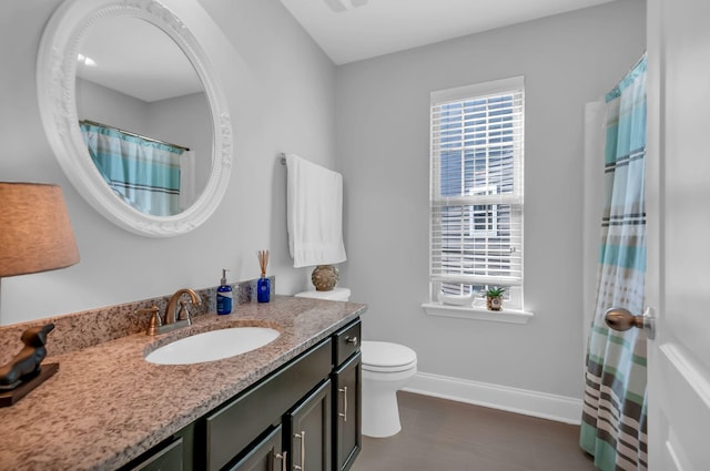 bathroom featuring vanity and toilet