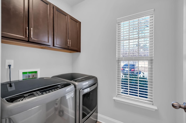 laundry room featuring cabinets and washer and dryer