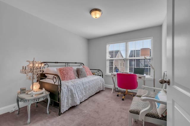 carpeted bedroom with an inviting chandelier