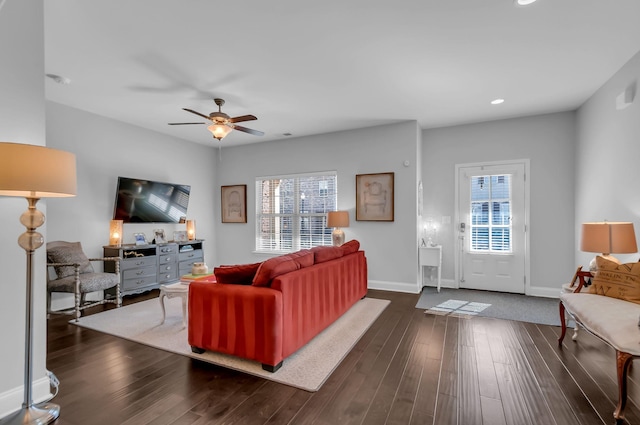 living room featuring a wealth of natural light, dark hardwood / wood-style floors, and ceiling fan