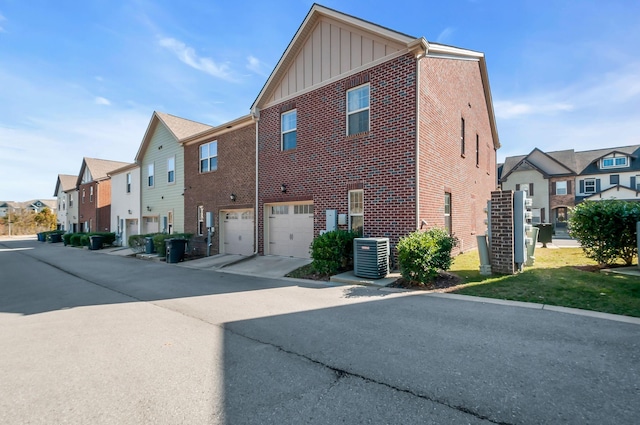 exterior space with a garage and central AC