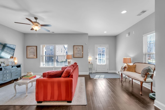 living room with dark hardwood / wood-style flooring, plenty of natural light, and ceiling fan