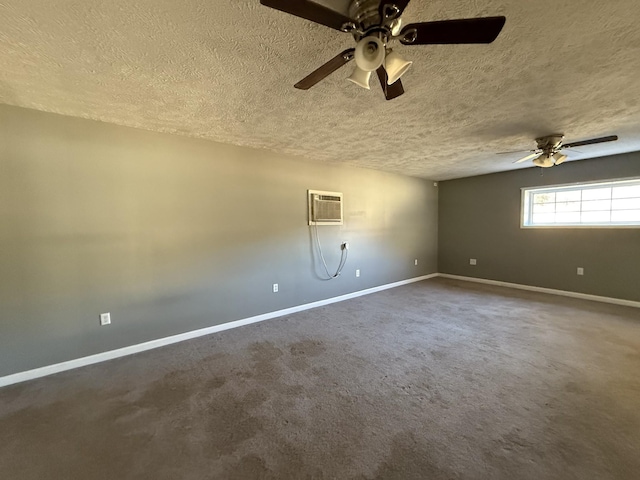 carpeted spare room with an AC wall unit and a textured ceiling