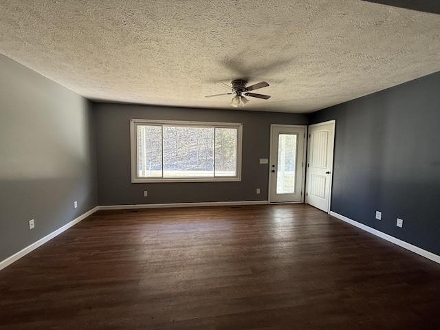 unfurnished room featuring a textured ceiling, dark wood-type flooring, and ceiling fan