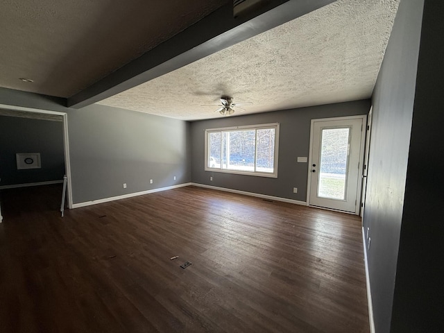 unfurnished living room with ceiling fan, dark hardwood / wood-style floors, and a textured ceiling