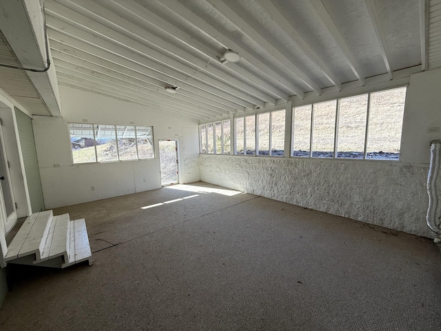 unfurnished sunroom featuring vaulted ceiling