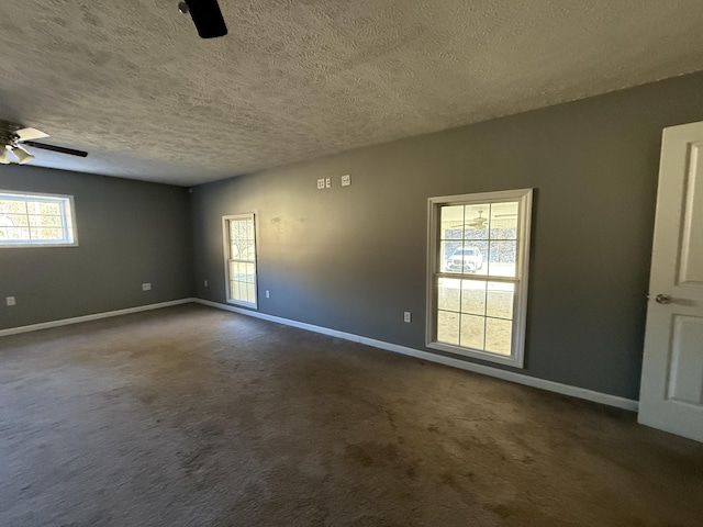 carpeted empty room with ceiling fan and a textured ceiling