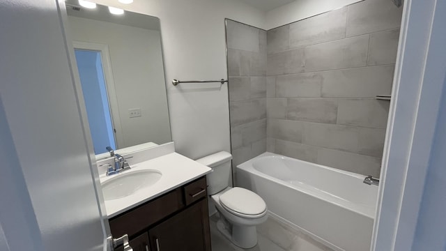 full bathroom with vanity, tiled shower / bath, and toilet