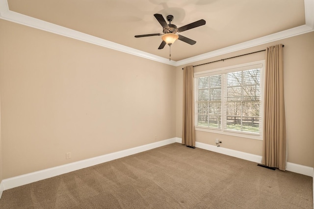 carpeted spare room featuring crown molding and ceiling fan