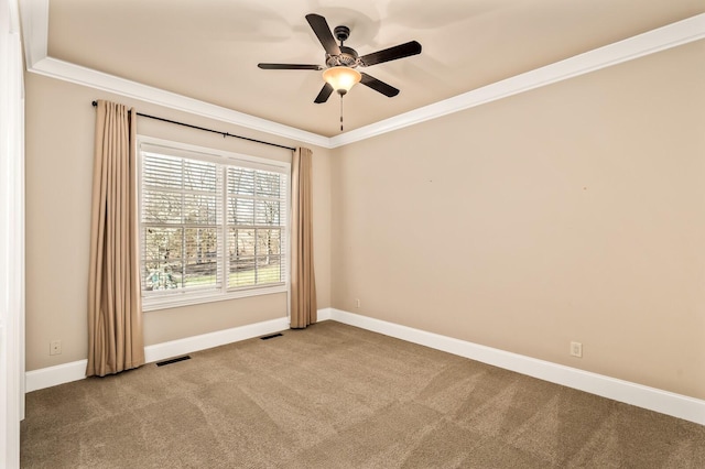 carpeted empty room with ceiling fan and ornamental molding