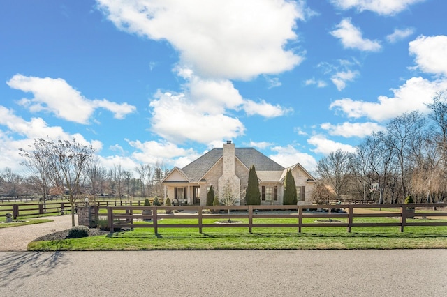 view of home's community with a lawn and a rural view