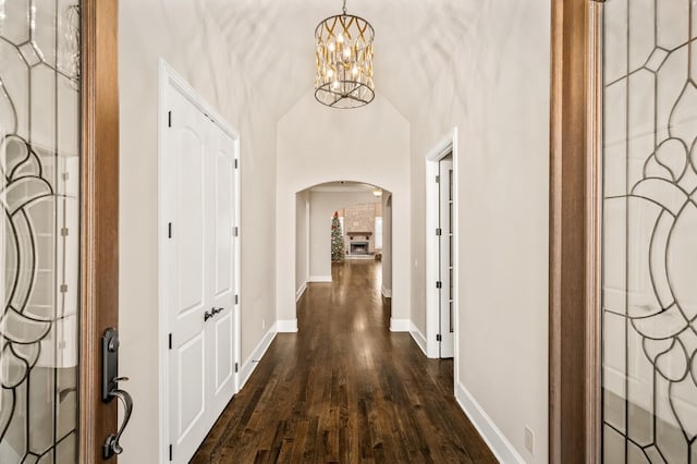 hallway with an inviting chandelier and dark hardwood / wood-style floors