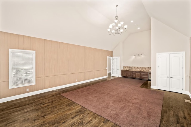 interior space featuring high vaulted ceiling, a chandelier, and hardwood / wood-style floors