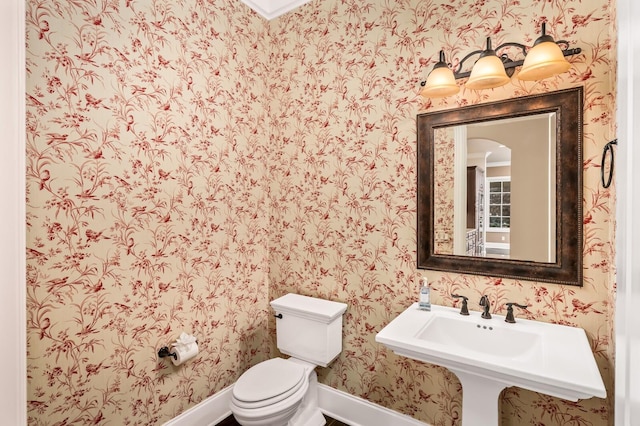 bathroom featuring toilet and sink