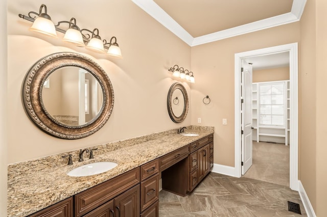 bathroom featuring ornamental molding and vanity