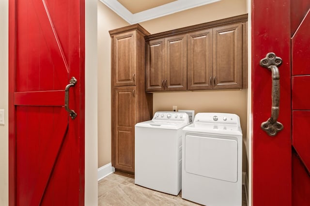 laundry room with cabinets, ornamental molding, and washer and dryer