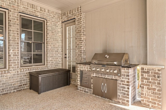 view of patio with area for grilling and exterior kitchen