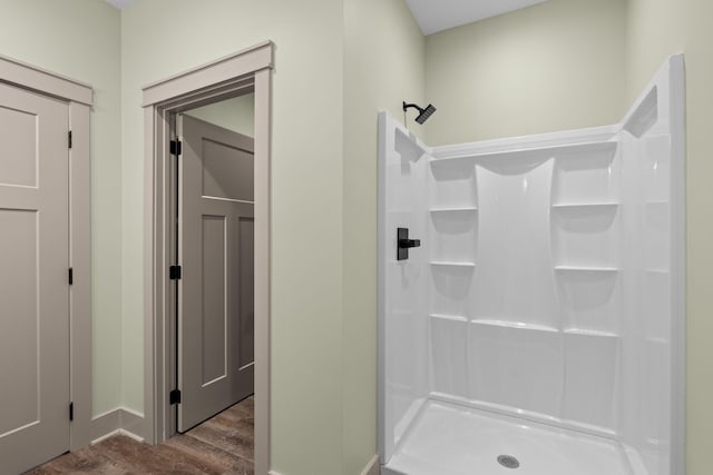 bathroom with wood-type flooring and a shower