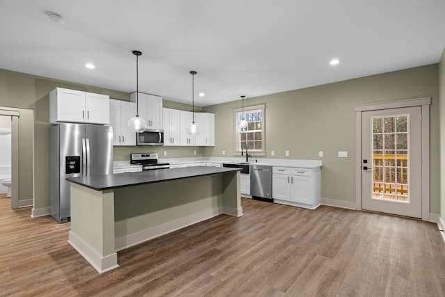 kitchen featuring white cabinetry, appliances with stainless steel finishes, and a center island