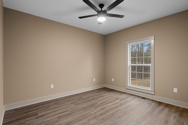 unfurnished room with hardwood / wood-style floors and ceiling fan