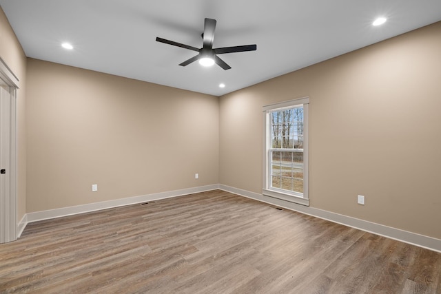 empty room featuring ceiling fan and light hardwood / wood-style flooring