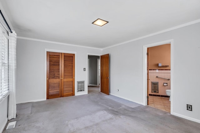 unfurnished bedroom featuring crown molding, light colored carpet, ensuite bath, and a closet