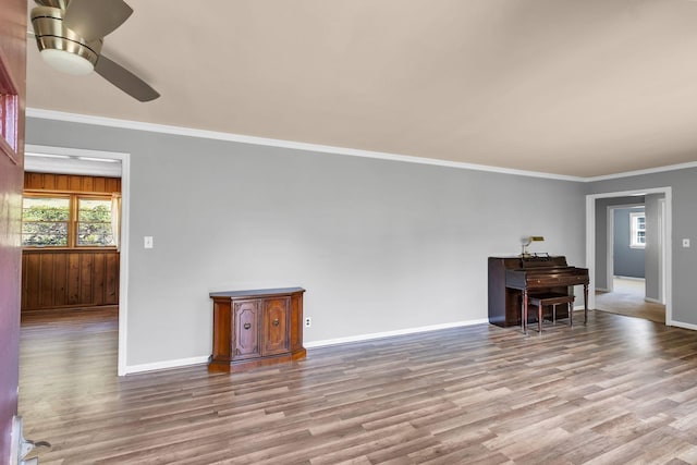 living room with ceiling fan, ornamental molding, and light hardwood / wood-style floors