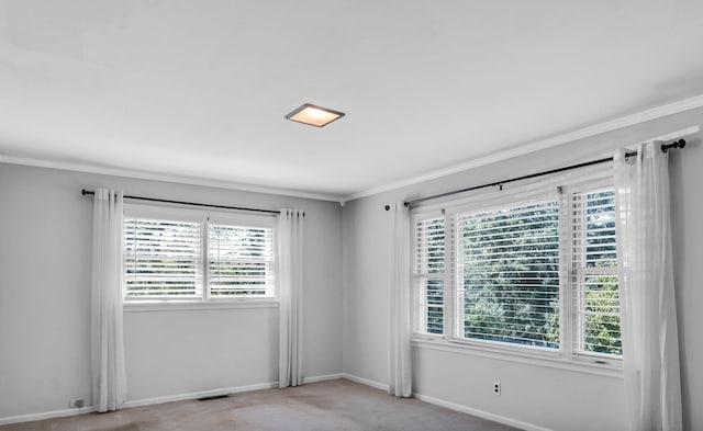 carpeted empty room featuring ornamental molding