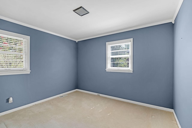 empty room with crown molding and light carpet