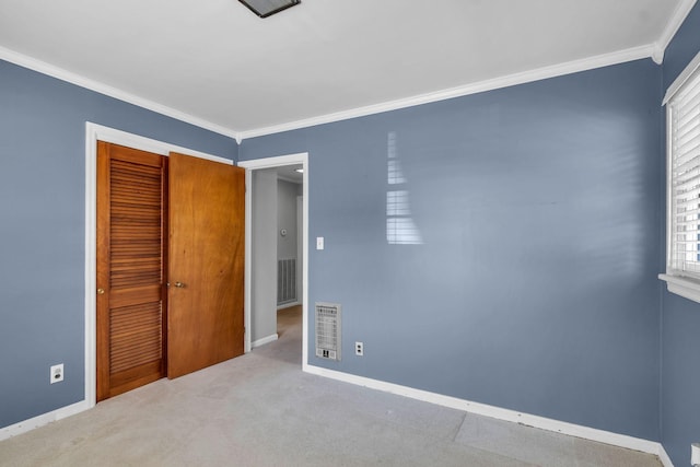 unfurnished bedroom with light colored carpet, ornamental molding, and a closet