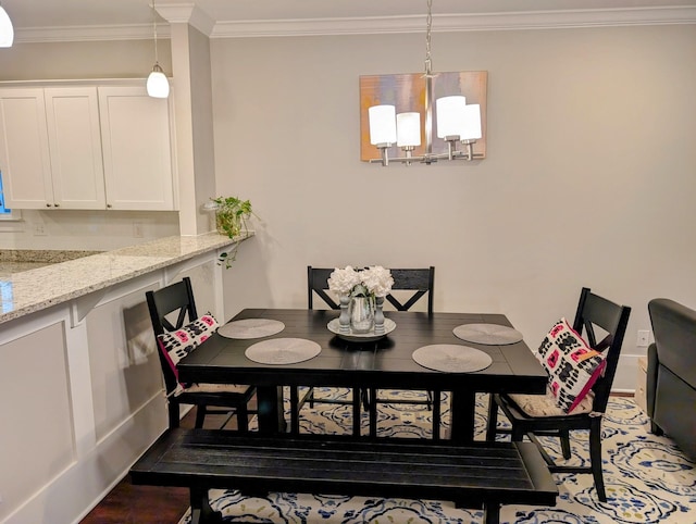 dining room featuring ornamental molding and a notable chandelier