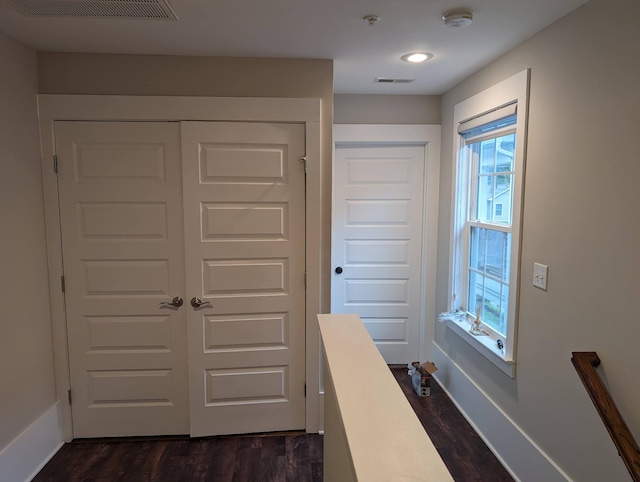 hallway with dark wood-type flooring