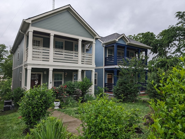 view of front of property with a balcony and central air condition unit