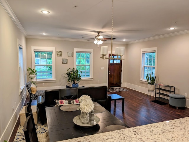 dining room featuring dark hardwood / wood-style flooring, ornamental molding, and ceiling fan